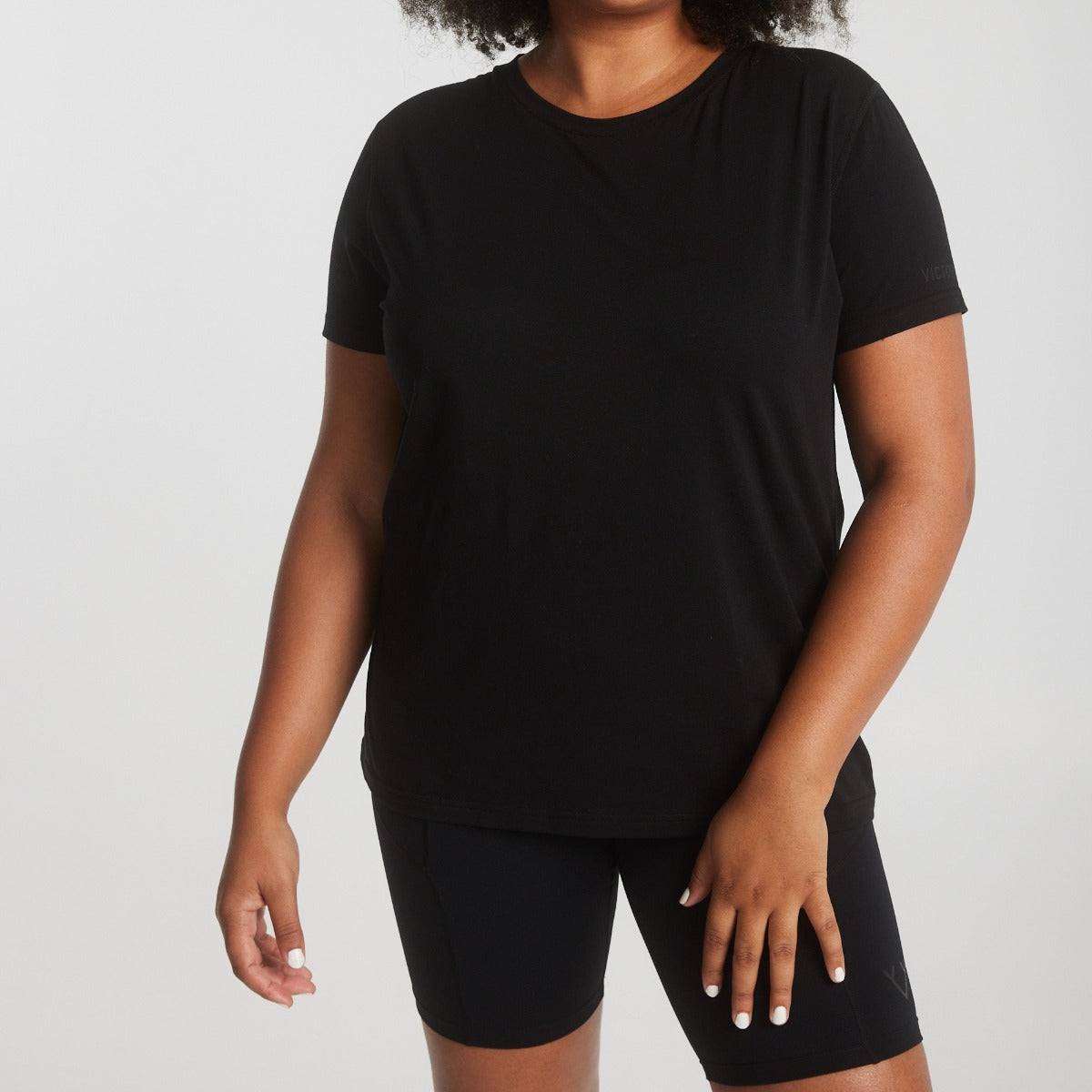 Woman wearing Victoria Stag's Core Trainer Tee in Black front closer look